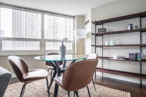 a dining room with a glass table and chairs at River N 2BR w Gym WD nr Magnificent Mile CHI-160 in Chicago
