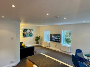 a living room with a couch and a table at The Apartment, Bridge House in Laxey