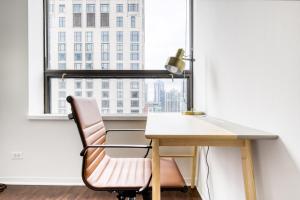 a desk and a chair in a room with a window at Streeterville 1BR w Gym Pool nr Navy Pier CHI-411 in Chicago