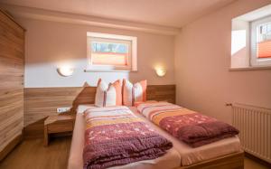 a bedroom with a large bed with two pillows at Mountainpeak in Mayrhofen