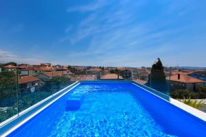 a large blue swimming pool with a view of a city at Luxury Rooms LaVie - Standard Rooms in Zadar