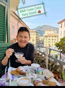 un homme assis à une table avec un bol de nourriture dans l'établissement B&B Casa Celsi, à La Spezia