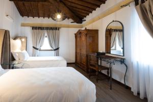 A bed or beds in a room at Castrum Wine Relais