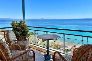 a balcony with chairs and a view of the ocean at Irini Traditional House Afitos in Afitos