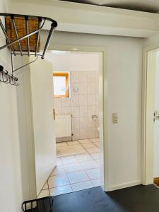 a view of a bathroom from the hallway of a house at Landurlaub auf Hinners-Hoff in Bendingbostel