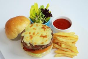 a white plate with a hamburger and french fries andetchup at Four Points by Sheraton Chongqing, Yongchuan in Yongchuan