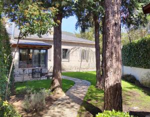 a group of trees in front of a house at El Chalet de Navacerrada in Navacerrada