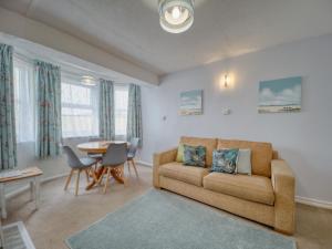 a living room with a couch and a table at Apartment 7 - 1 bedroom Sea front location - Step free access from rear - Free Parking in Paignton