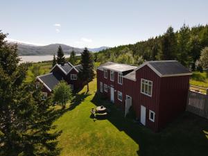an aerial view of a red barn with a house at Hengifosslodge Skáldahús in Egilsstadir