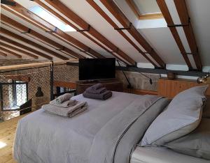 a bedroom with a large bed with towels on it at El Chalet de Navacerrada in Navacerrada