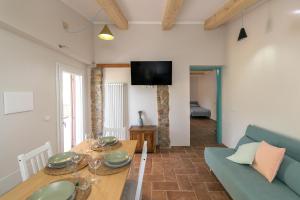 uma sala de estar com uma mesa e um sofá azul em Al posto giusto -appartamento Gioia em Riotorto