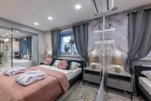 a bedroom with two beds and a bath tub at MM Rooms in Bled
