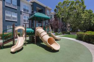 a playground with a slide in front of a building at Sunnyvale 1br w gym pool wd nr highways SFO-1330 in Sunnyvale