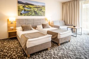 Postel nebo postele na pokoji v ubytování Hotel Kaskáda