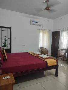 a bedroom with a large bed in a room at CASA LORETA in Varkala