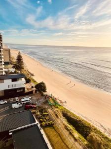 an aerial view of a beach and the ocean at Absolute Beachfront Luxury - Heated Pool - 75 TV in Gold Coast