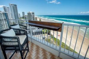 a balcony with two chairs and a view of the beach at ABSOLUTELY STUNNING! ON THE BEACH !!! in Gold Coast