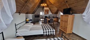 a living room with two beds and a kitchen at Domek Gabi z balią w ogrodzie in Zakopane