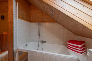 a bathroom with a tub in a attic at Haus Monika Silvrettablick in Sankt Gallenkirch