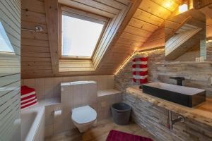 a bathroom with a sink and a toilet and a tub at Haus Monika Silvrettablick in Sankt Gallenkirch