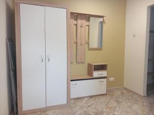 a bathroom with a white closet and a mirror at Sunny Ventspils 21 in Ventspils +1 photo