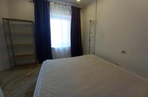 a bedroom with a large bed and a window at Sunny Ventspils 21 in Ventspils