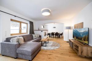 a living room with a couch and a table at Apartments Austria in Söll