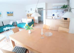 a dining room and living room with a table and chairs at Hafenglück in Breege