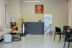 a living room with a couch and a table and chairs at Khe Suites Serviced Apartment - Han River in Danang