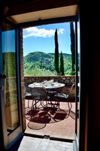 a table and chairs on a patio with a view at Agriturismo Vinci in Gaiole in Chianti