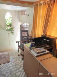 a living room with a kitchen with a counter top at Kesher Paying Guest House in Varanasi