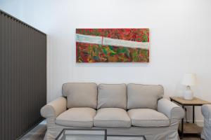 a living room with a couch and a painting on the wall at Holi-Rent AT Erillas in Camas