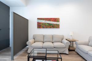 a living room with a couch and a table at Holi-Rent AT Erillas in Camas