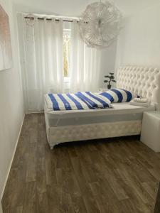 ハノーファーにある3 Zimmer Wohnungのベッドルーム1室(白と青の枕が備わる白いベッド1台付)