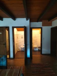 a room with two doors and a bathroom with a toilet at Köstlhof, Familie Hassler in Oberdrauburg