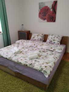 a bed in a bedroom with roses on it at Sejmen in Sarajevo