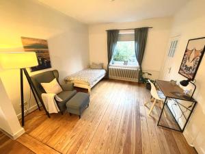 a living room with a couch and a chair and a table at Modern und ruhig in Elmshorn in Elmshorn