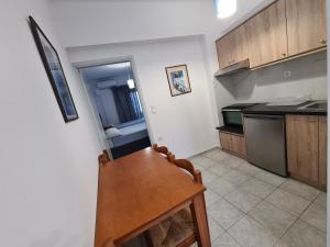 a kitchen with a wooden table and a counter top at Lyttos in Tsoútsouros