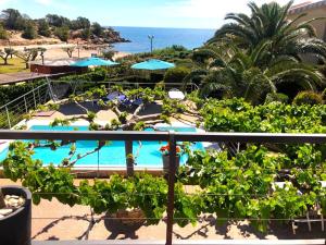 a view of a resort with a swimming pool and the ocean at Villa Playa in L'Ametlla de Mar