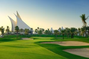 a golf course with a view of the resort at Dubai Creek Club Villas in Dubai