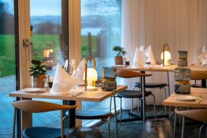 a row of tables in a restaurant with napkins at Skanderborg Park in Skanderborg