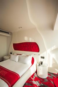 a bedroom with a bed with a red and white comforter at Guangzhou Planet Hotel in Guangzhou