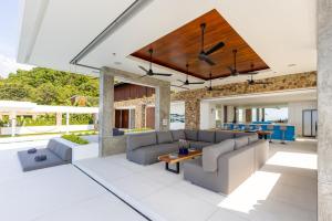 an open living room with couches and a table at Villa Blue View Luxe in Mae Nam