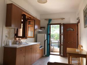 a kitchen with a sink and a refrigerator at Nikos Apartments A6 in Gialiskari