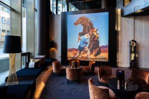 a lobby with a painting of a horse on the wall at The Thief in Oslo