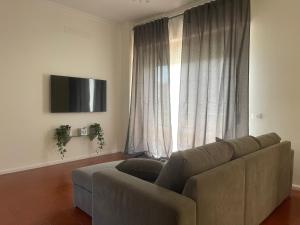 a living room with a couch and a large window at Anema & Core Home in Porto SantʼElpidio