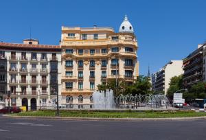 a building with a fountain in front of a building at Hotel Sardinero Madrid in Madrid