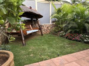 a garden with a chair and an umbrella at Luxury and Comfort Hideaway 2 - Solar Powered in Pretoria