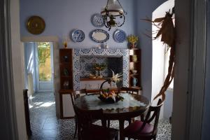a dining room with a table and a fireplace at Oikia Ahanasia in Karlovasi
