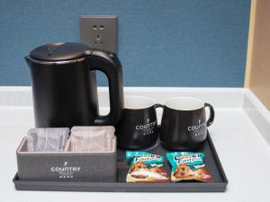 Příslušenství pro přípravu čaje a kávy v ubytování Country Inn & Suites by Radisson - Taishan East Branch